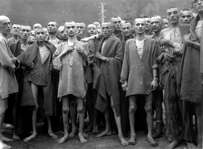 Starved prisoners, nearly dead from hunger, pose in concentration camp in Ebensee, Austria. The camp was reputedly used for "scientific" experiments. It was liberated by the 80th Division. May 7, 1945. Lt. A. E. Samuelson. (Army) NARA FILE #: 111-SC-204480 WAR & CONFLICT BOOK #: 1103